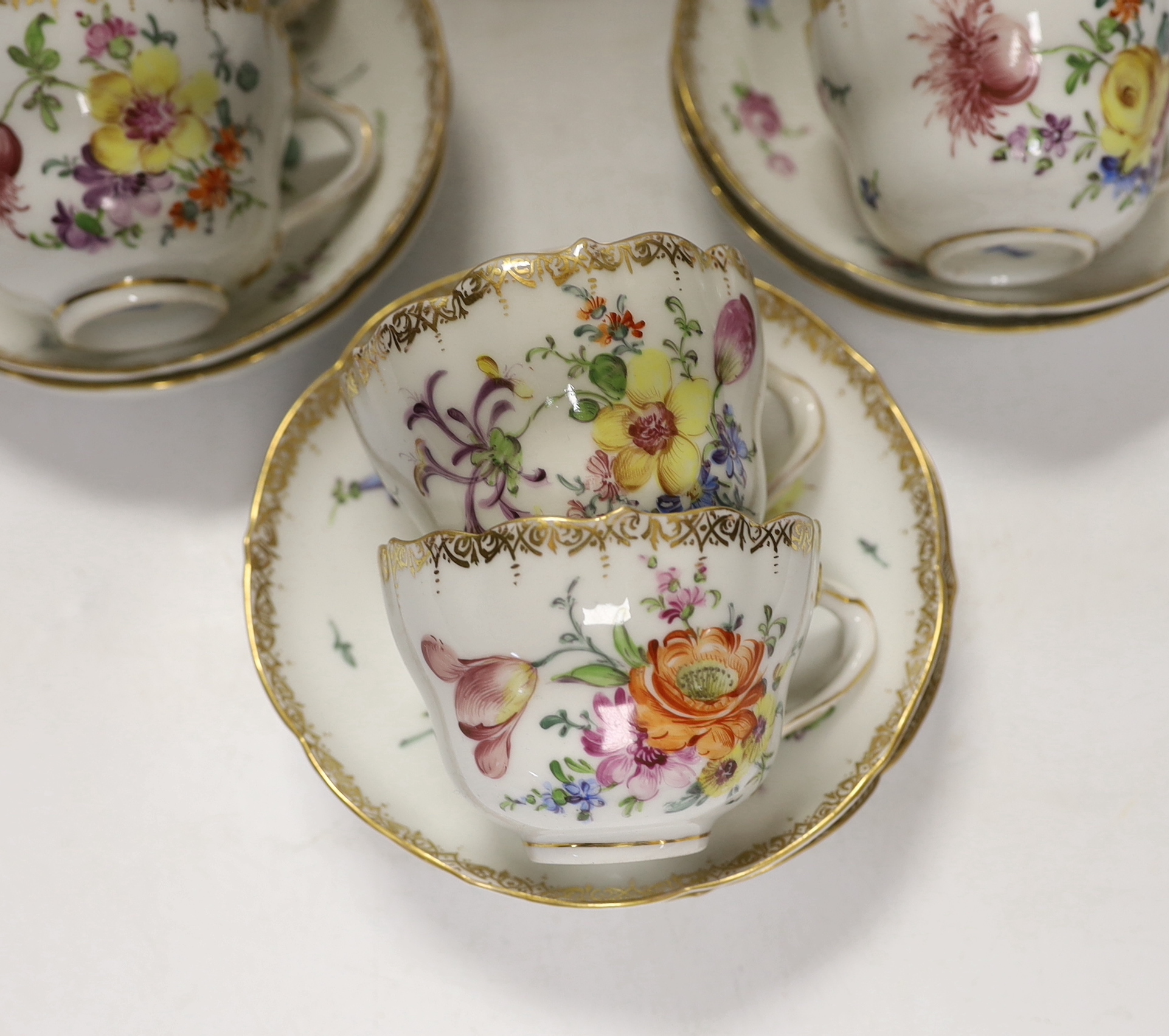 Twelve early 20th century Dresden floral tea cups and saucers
